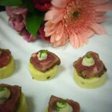 Seared Tenderloin of Beef with Fresh Basil Pesto on a Creamy Polenta Round